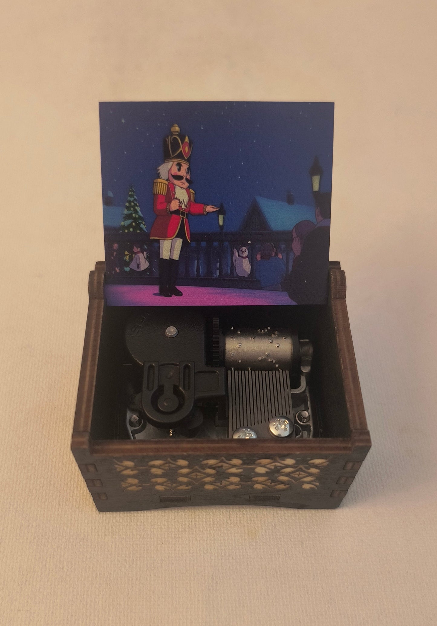 The nutcracker Wooden box with a small figurine inside on a beige background. Christmas ballet solider