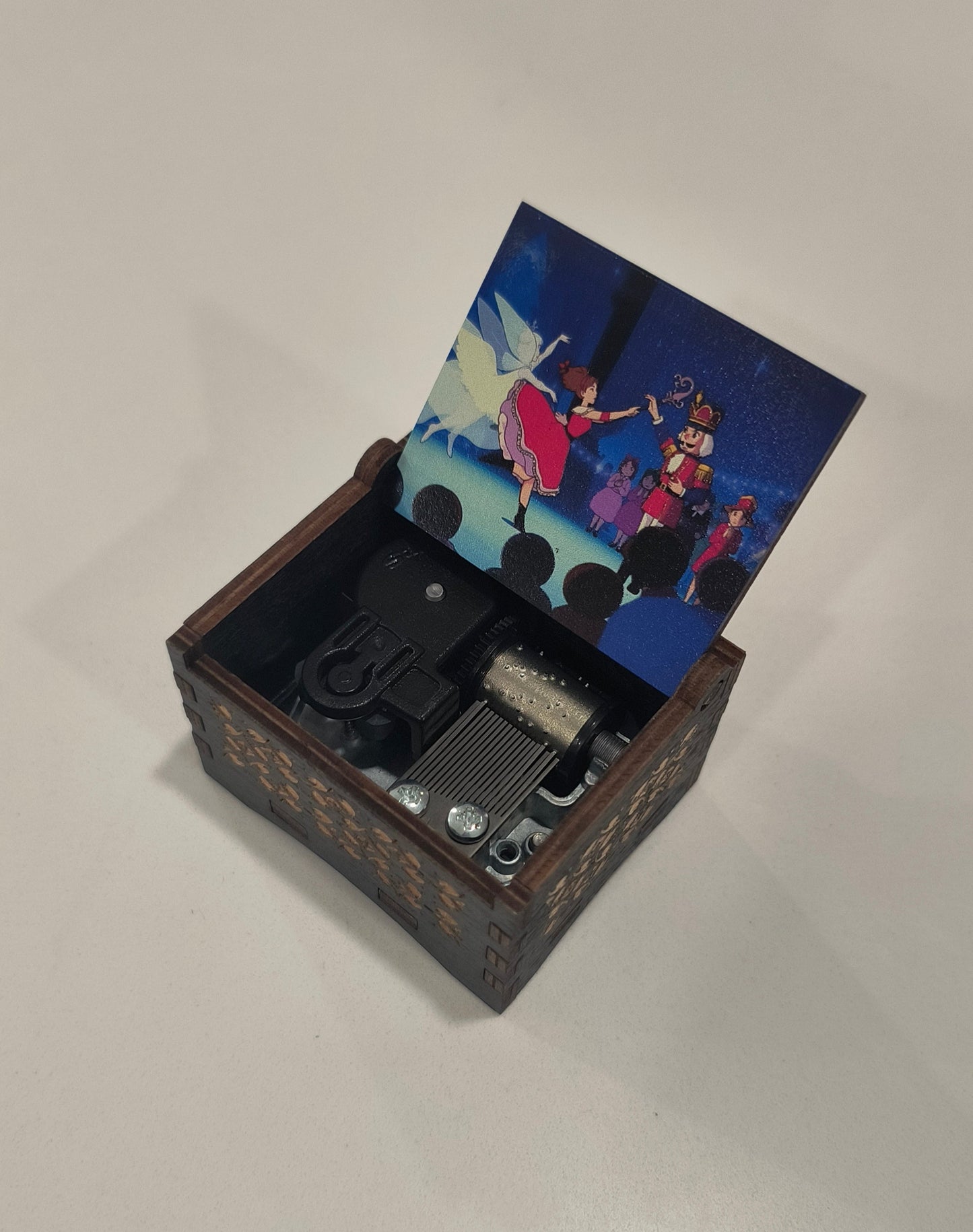 Wooden box with a small camera inside, featuring a colorful photo on the lid.