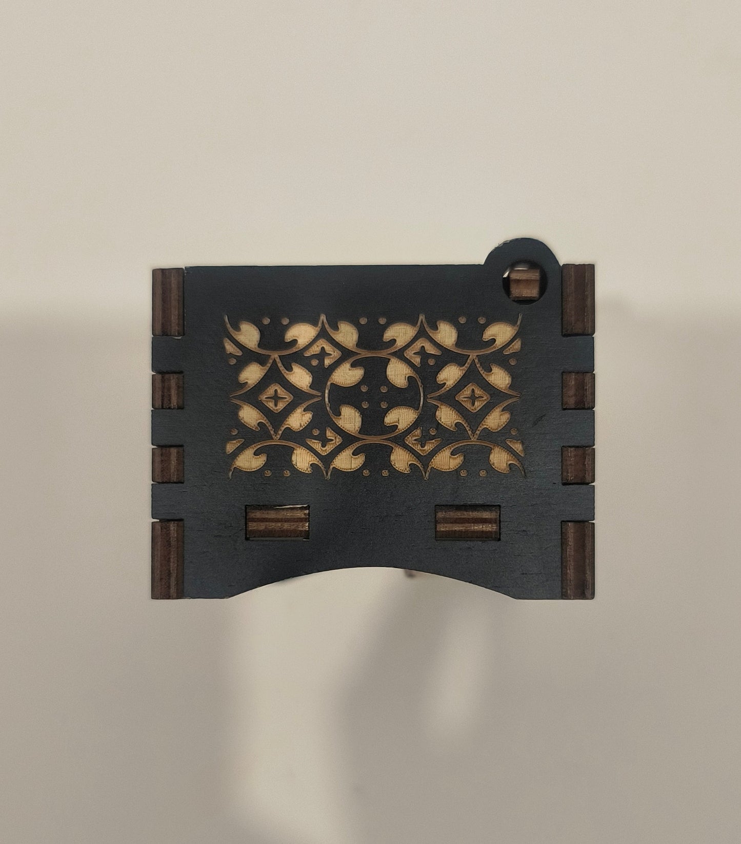 Decorative wooden block with intricate patterns on a plain background