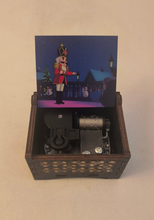 The nutcracker Wooden box with a small figurine inside on a beige background. Christmas ballet solider
