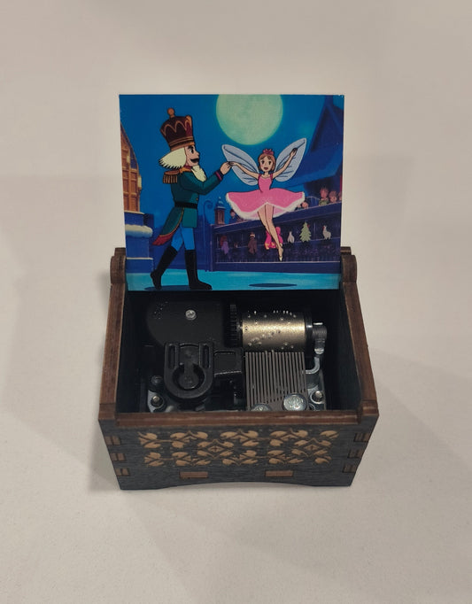 Wooden music box with a fairy and prince illustration on the lid.