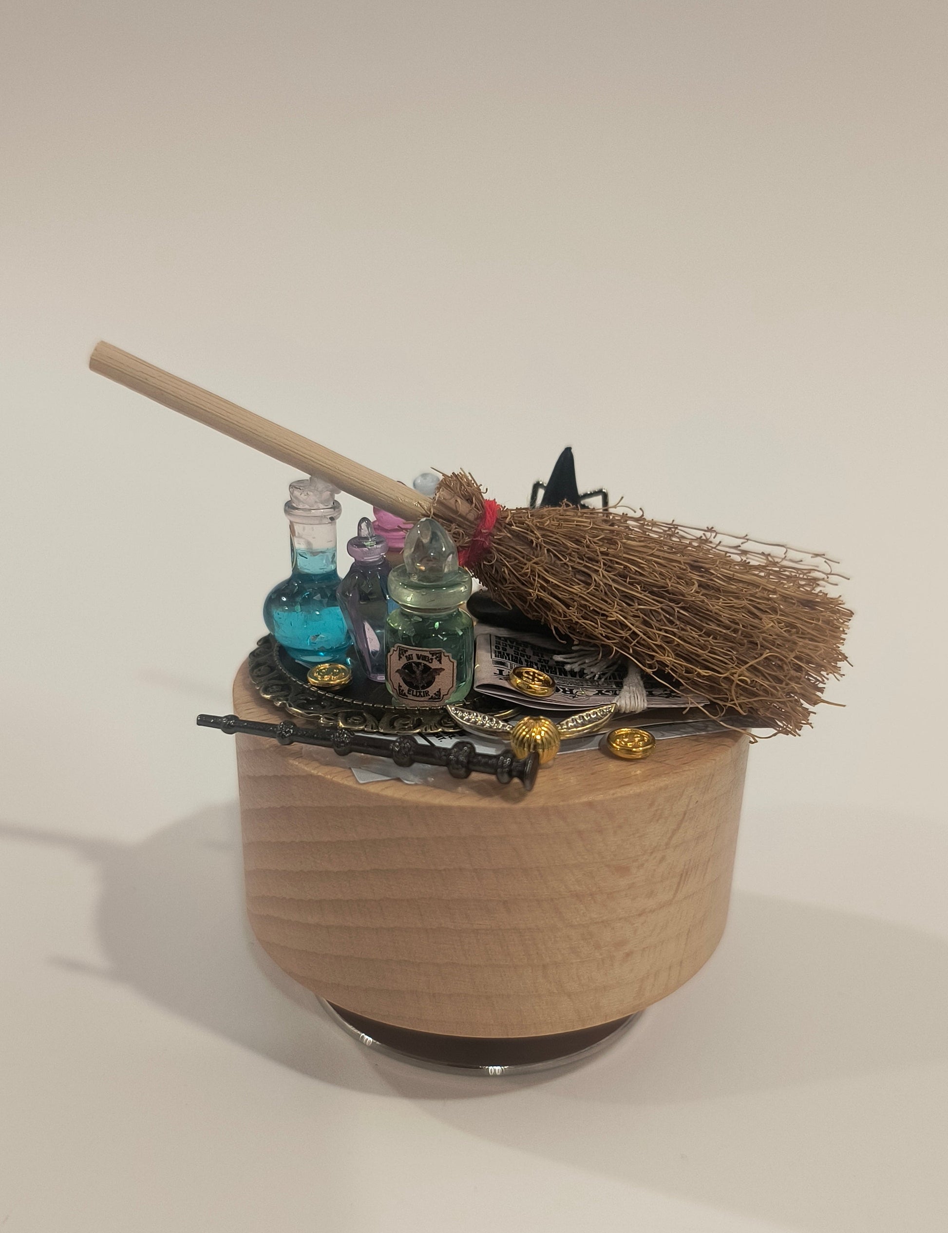 Small robot with a broom-like appendage on a white background