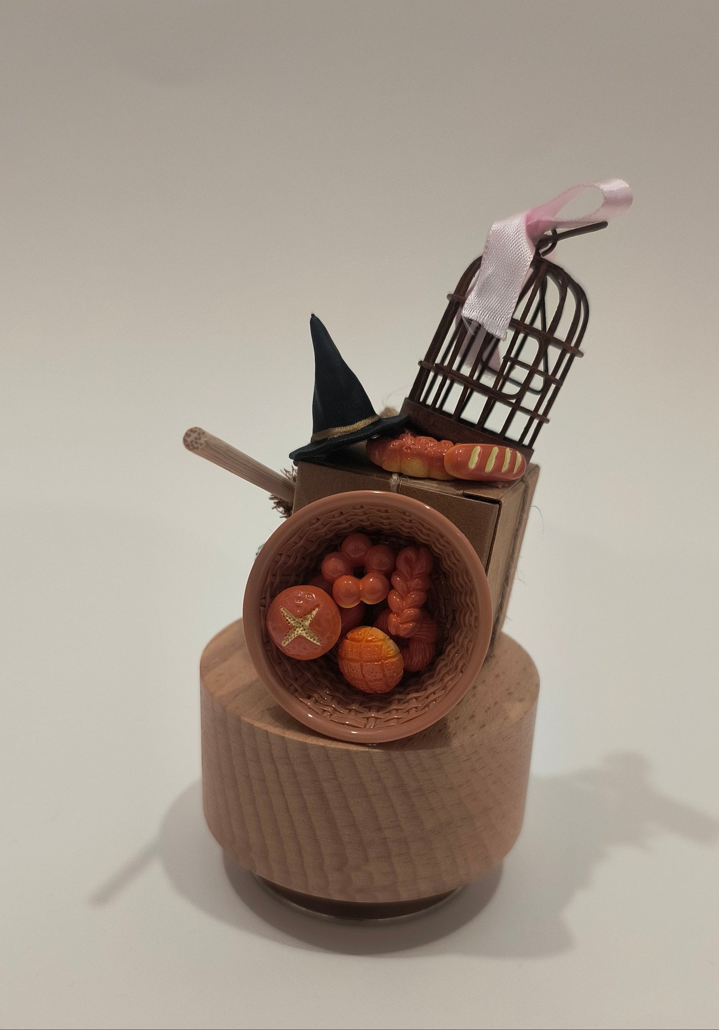 Decorative item with a black cat, basket, and strawberries on a white background