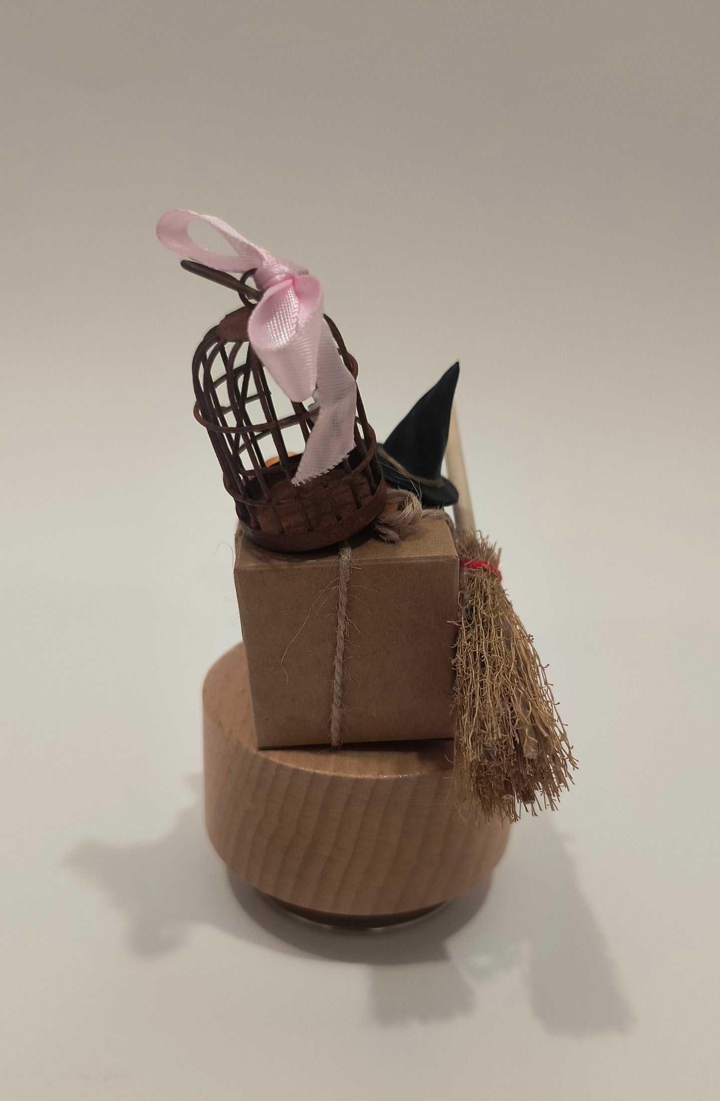 Decorative wall piece resembling a bird with a basket on a plain background