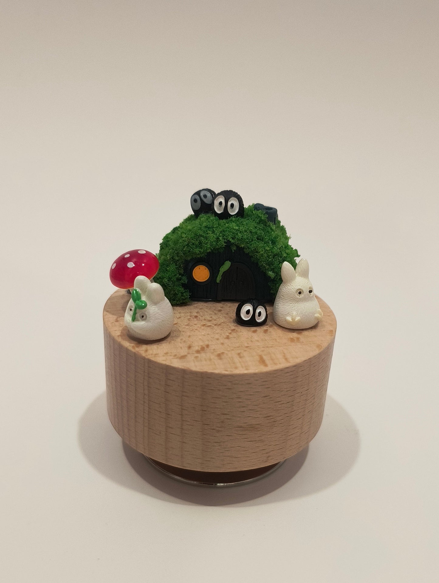 Decorative wall-mounted planter with a face on a plain background