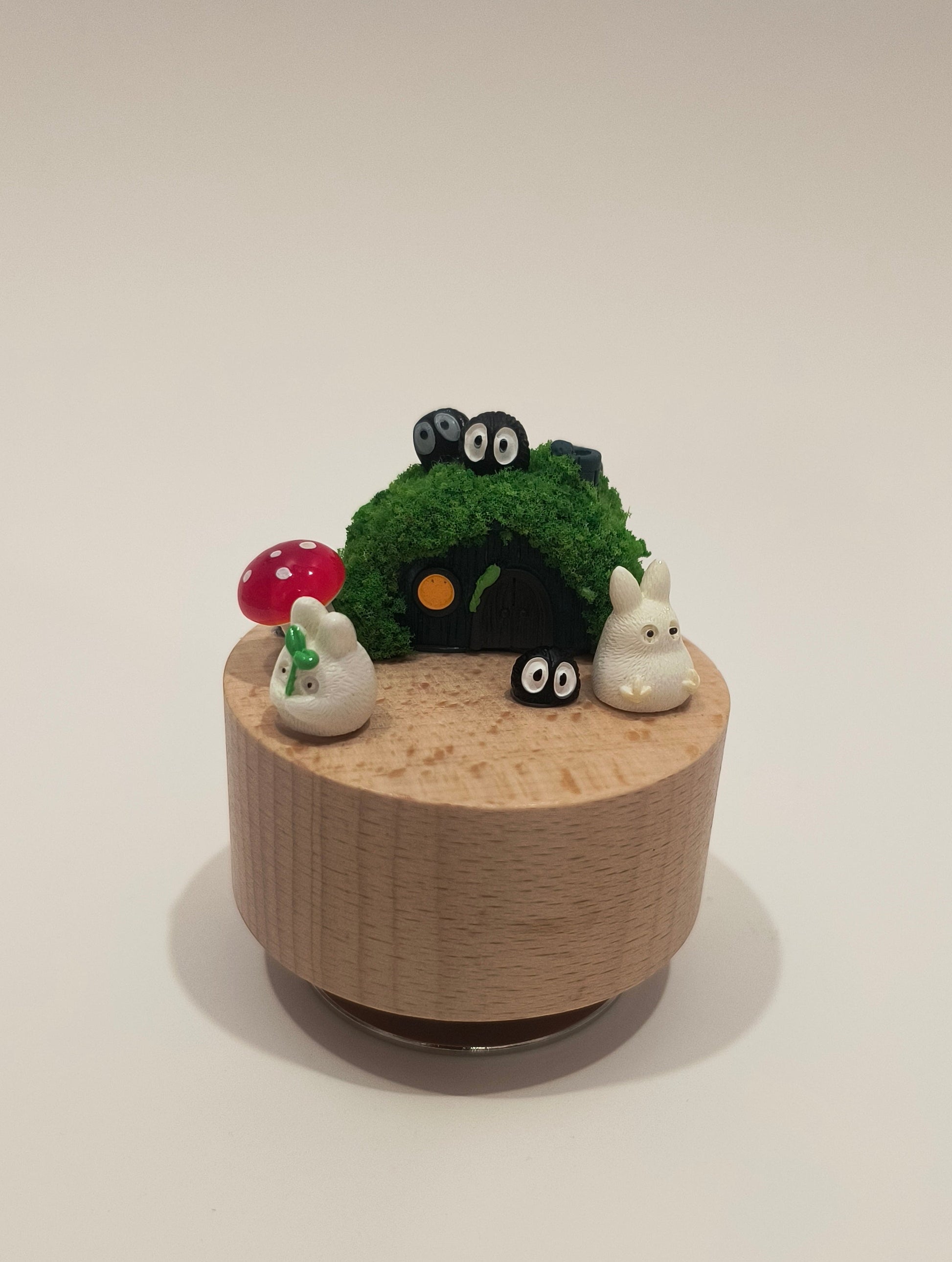 Decorative wall-mounted planter with a face on a plain background