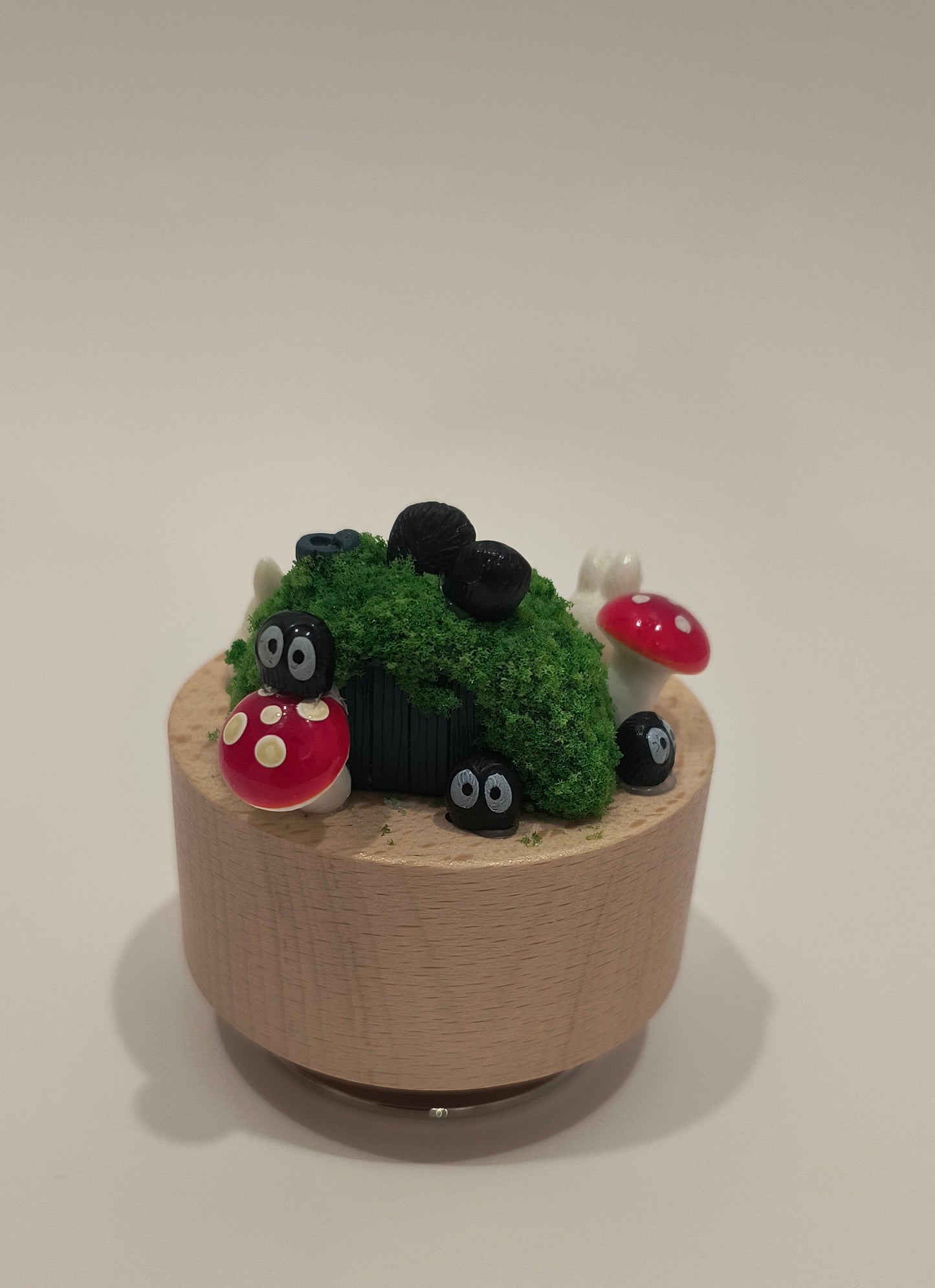 Small decorative garden with a cardboard tube base on a plain background