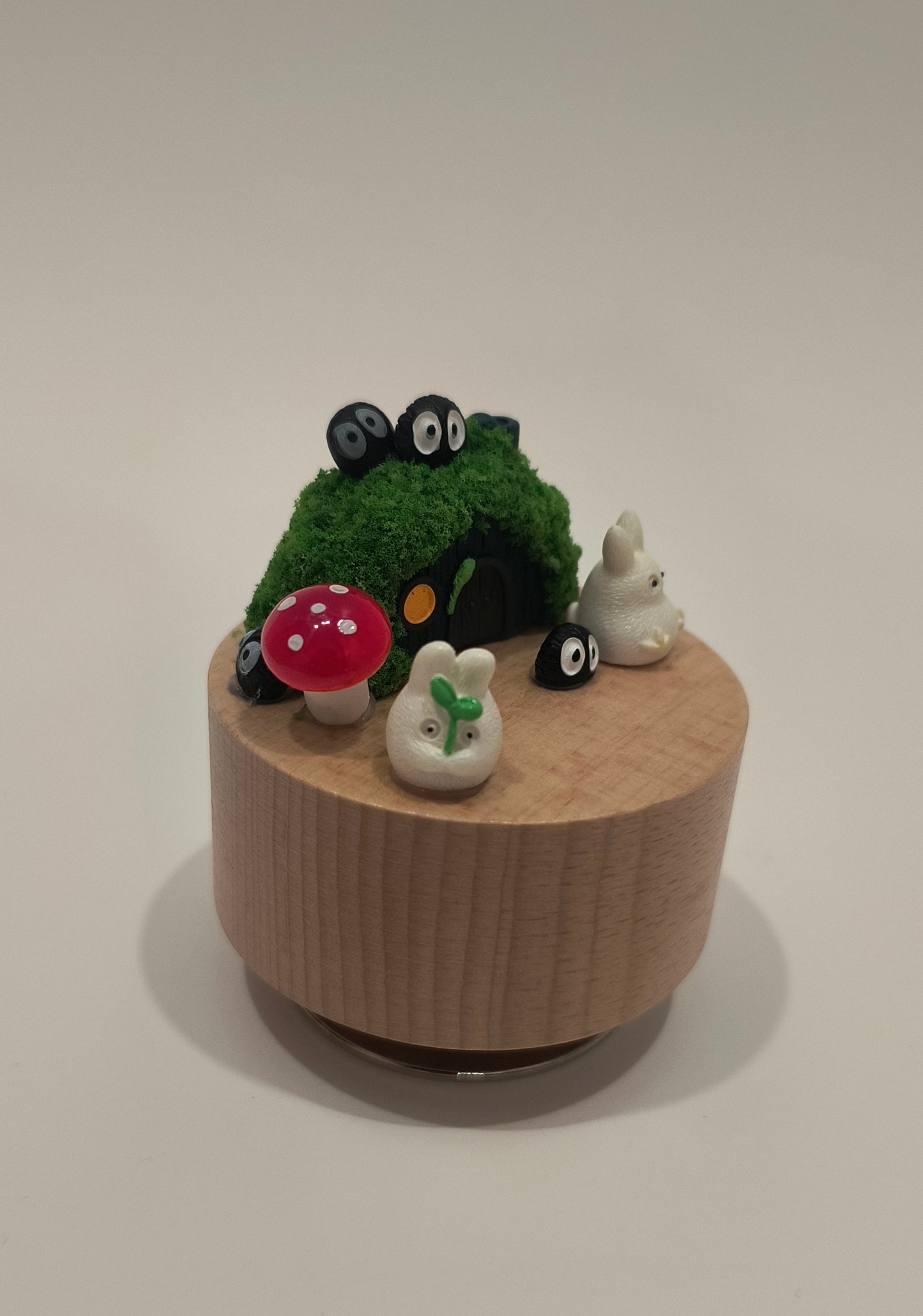 Small decorative garden with a wooden base on a plain background