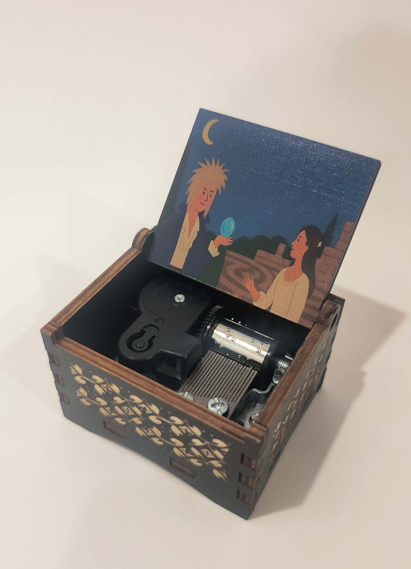 Decorative box with a lid featuring an illustration of a person and a lion on a white background.