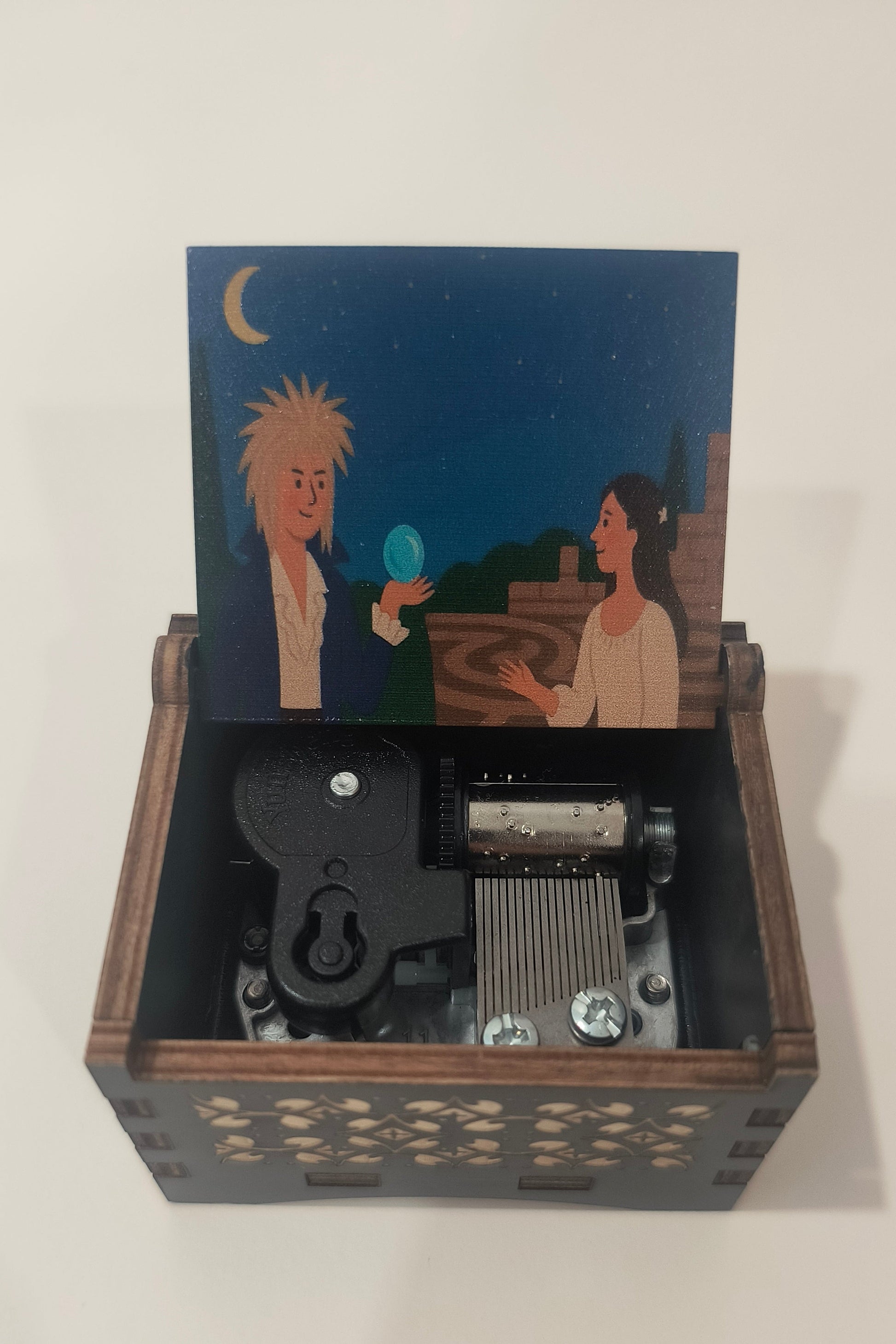Wooden mechanical box with a printed illustration on a white background