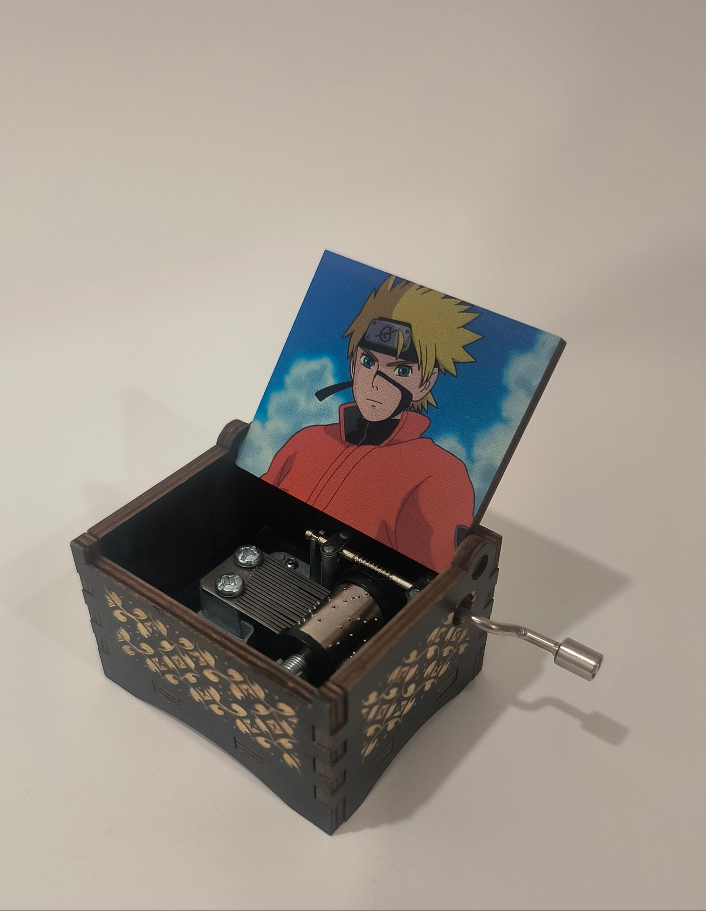 Small mechanical device with a card featuring a character on a plain background