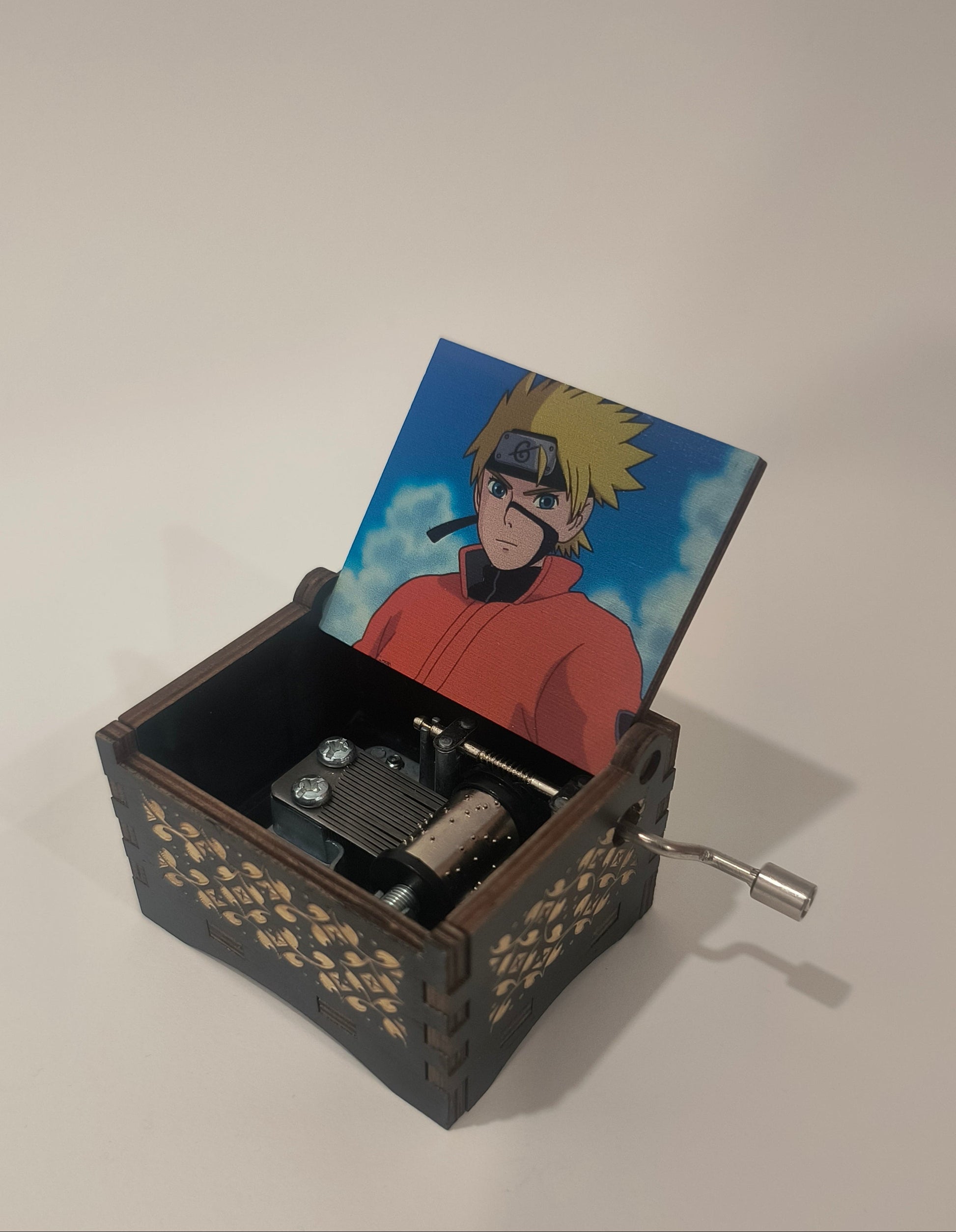 Small mechanical device with a card featuring a character on a plain background