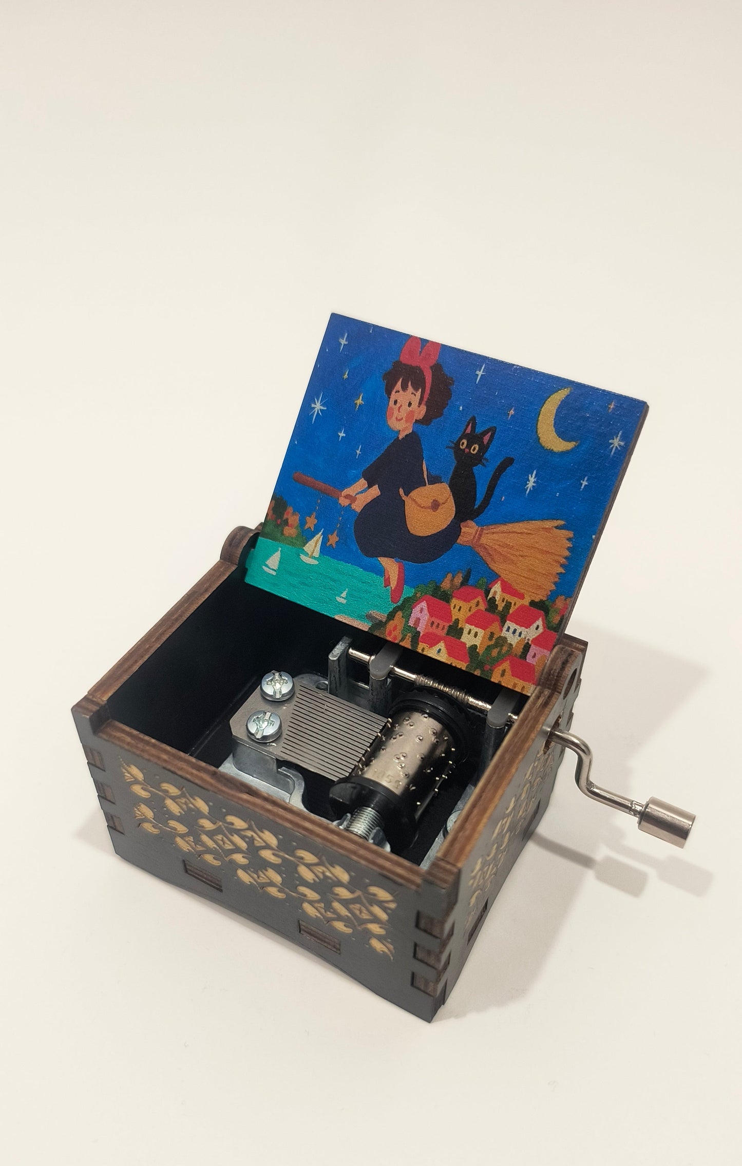 Vintage-style music box with a colorful illustration on the lid