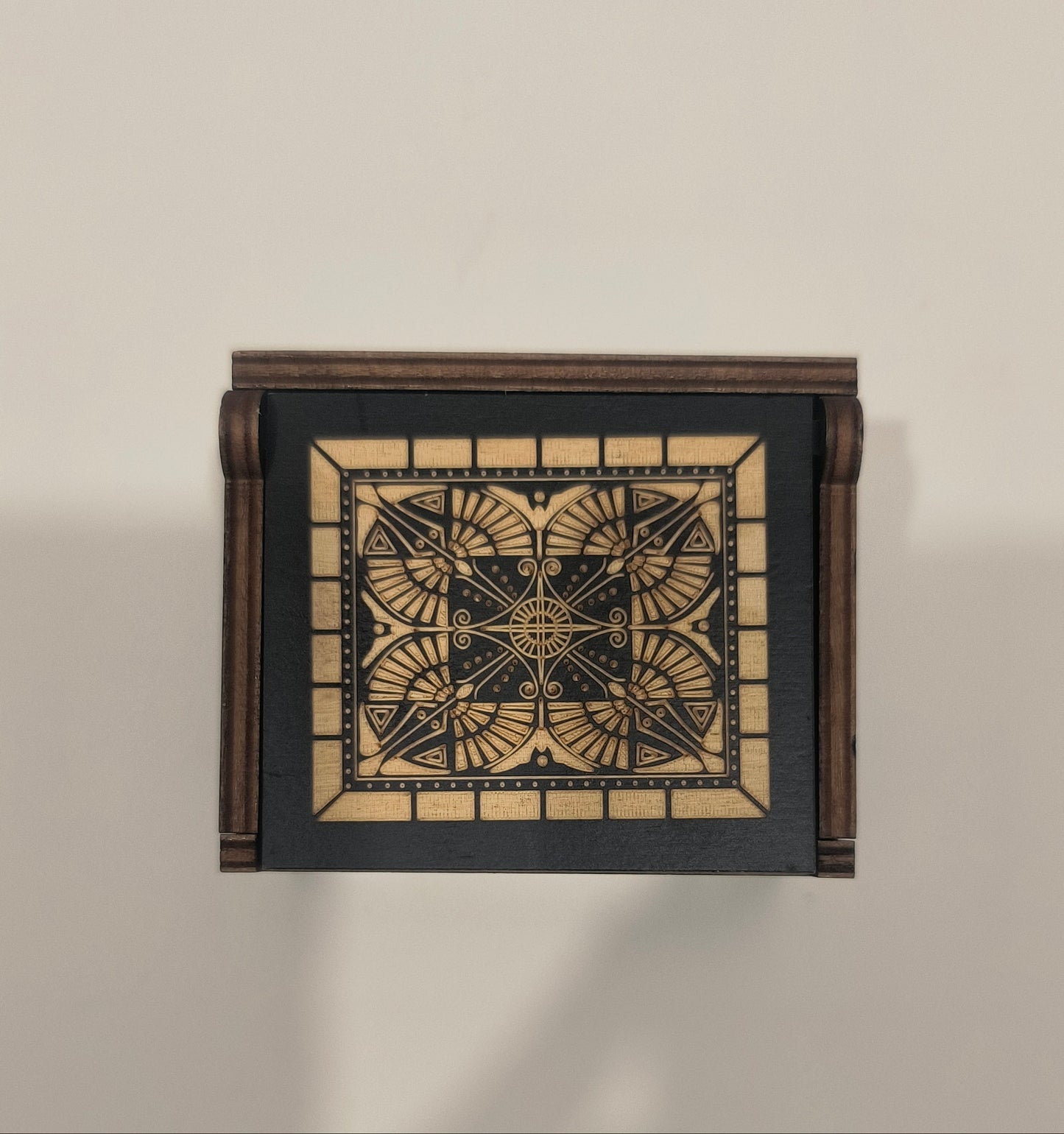 Decorative wall light fixture with geometric design on a beige background