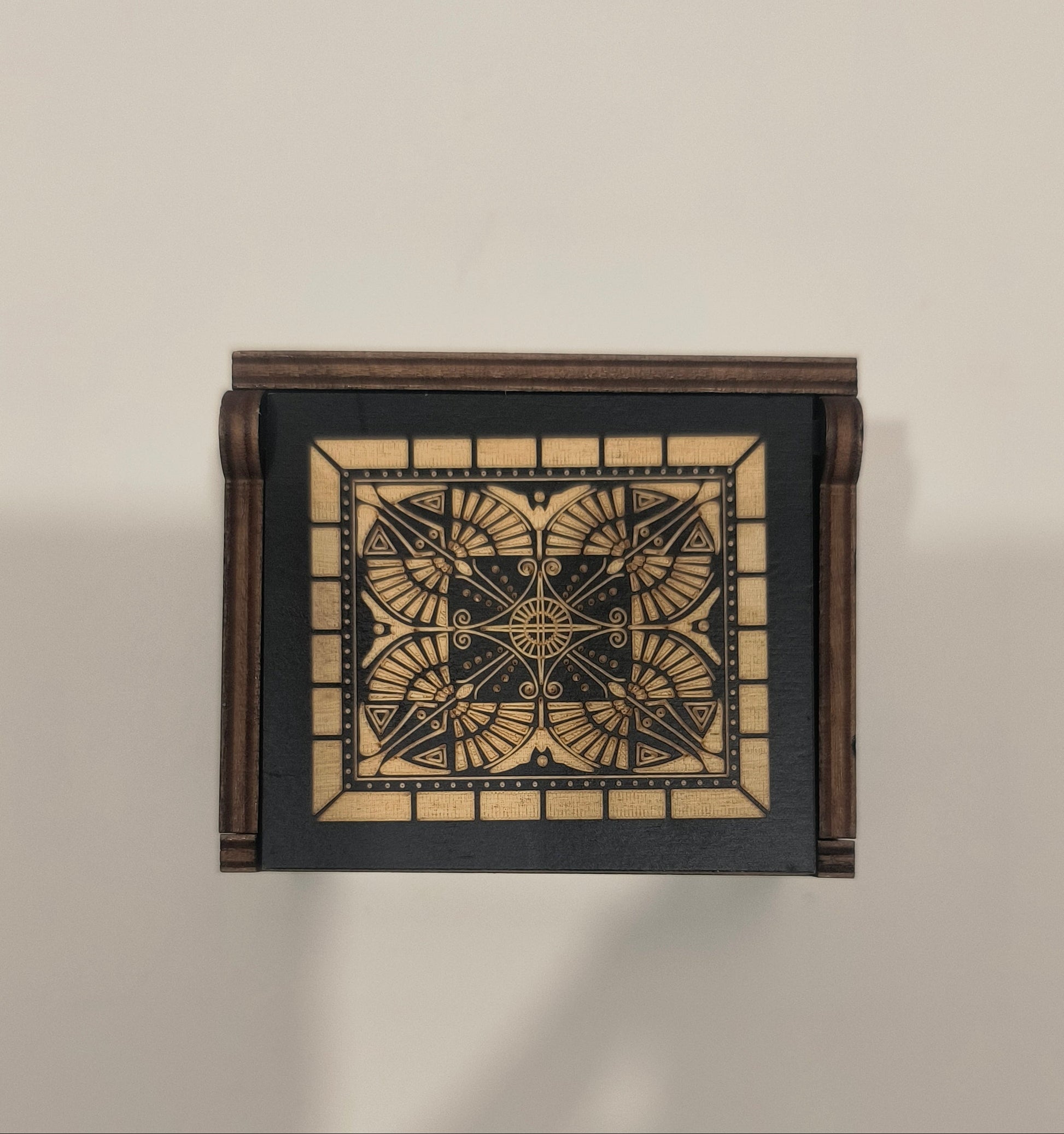 Decorative wall light fixture with geometric design on a beige background