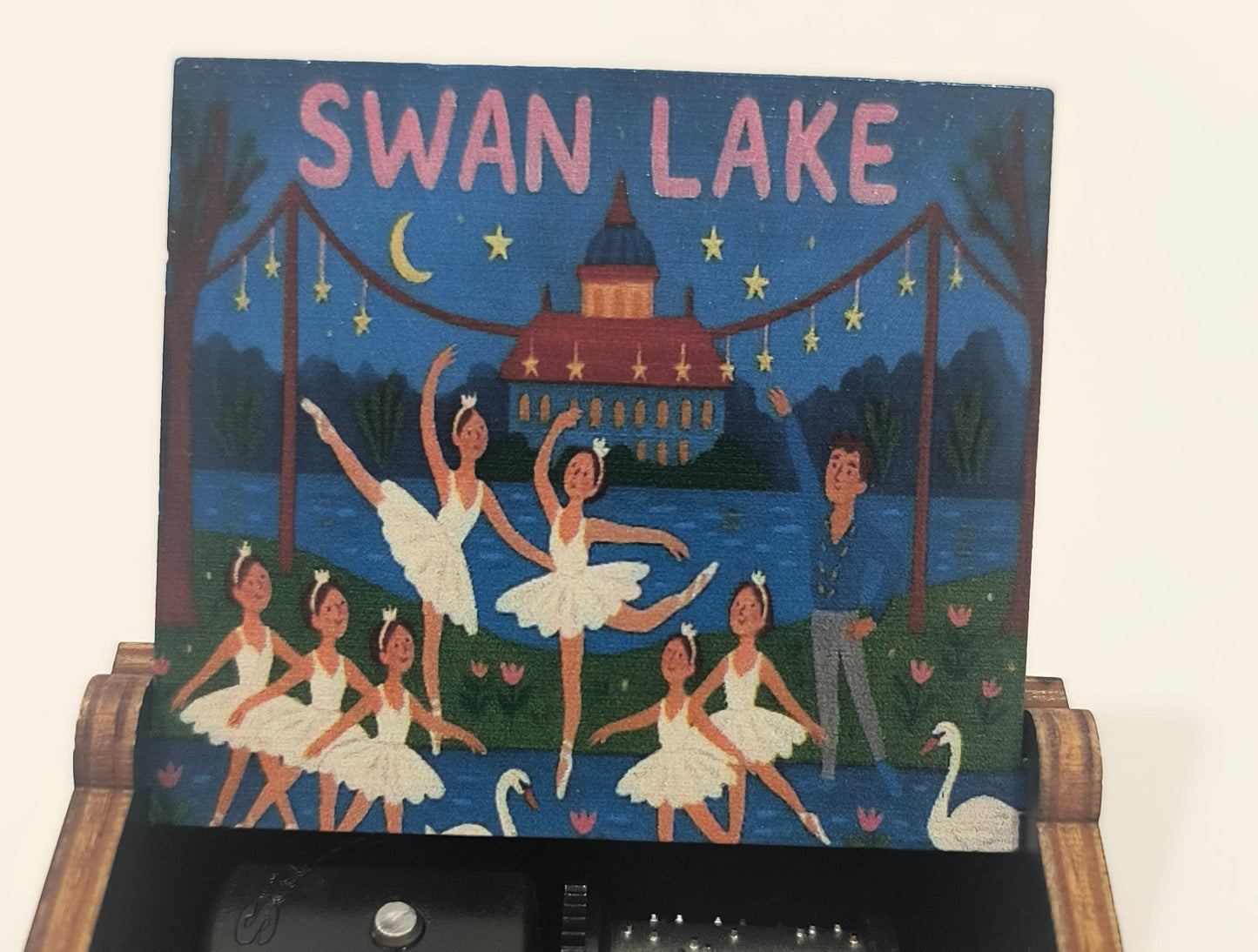 Decorative box with 'Swan Lake' design and mechanical components inside