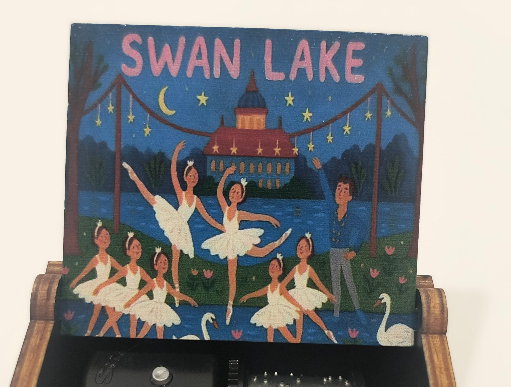Decorative box with 'Swan Lake' design and mechanical components inside