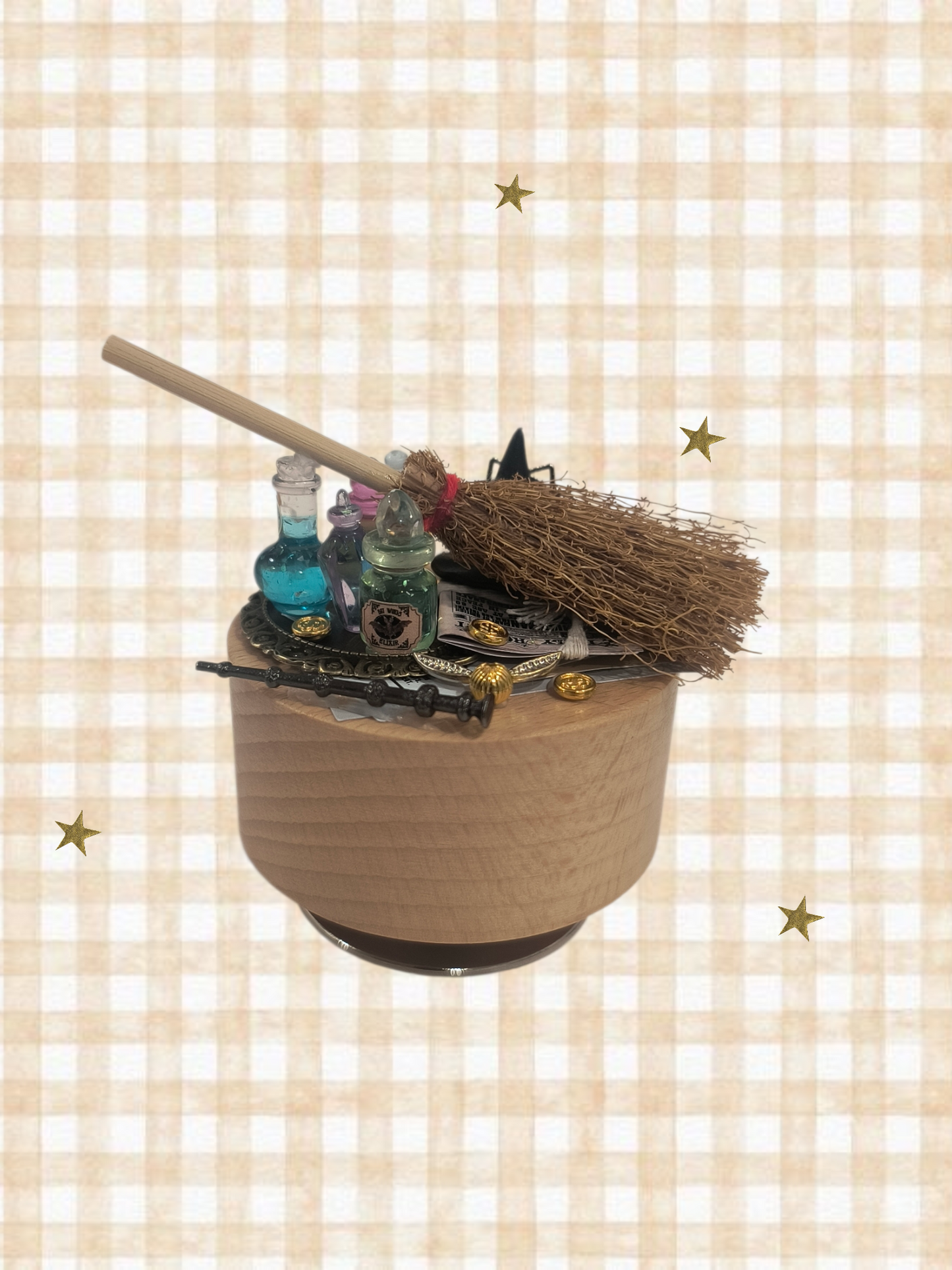 Witch's cauldron with broom and bottles on a checkered background. Harry Potter music box